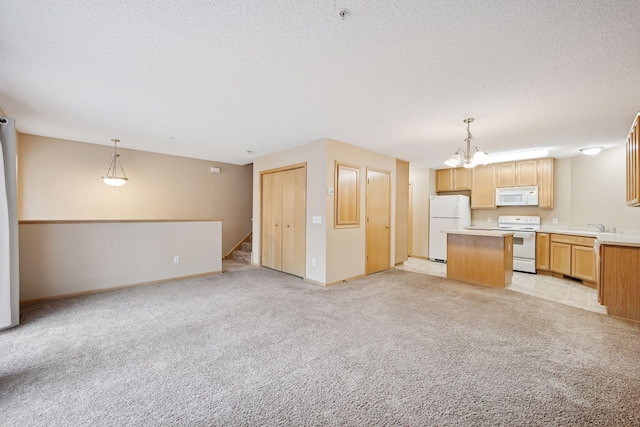 17641 69th Pl N, Maple Grove, MN 55311 - kitchen with white appliances, open floor plan, a center island, a chandelier, and light countertops