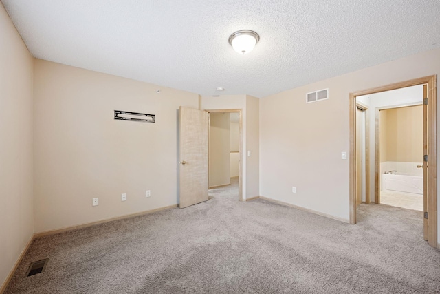 17641 69th Pl N, Maple Grove, MN 55311 - unfurnished bedroom featuring light carpet and a textured ceiling