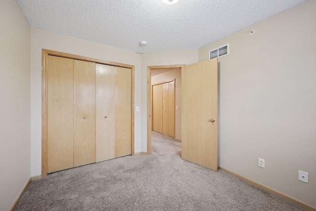 17641 69th Pl N, Maple Grove, MN 55311 - unfurnished bedroom featuring carpet, a closet, and a textured ceiling