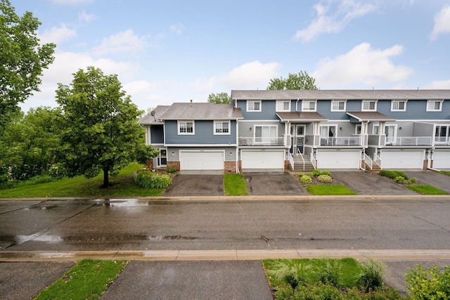 17641 69th Pl N, Maple Grove, MN 55311 - view of property featuring brick siding, driveway, and an attached garage