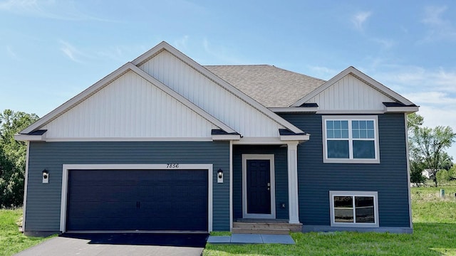 7856 Martin Ave NE, Otsego, MN 55330 - view of front of home with an attached garage, asphalt driveway, board and batten siding, and a shingled roof