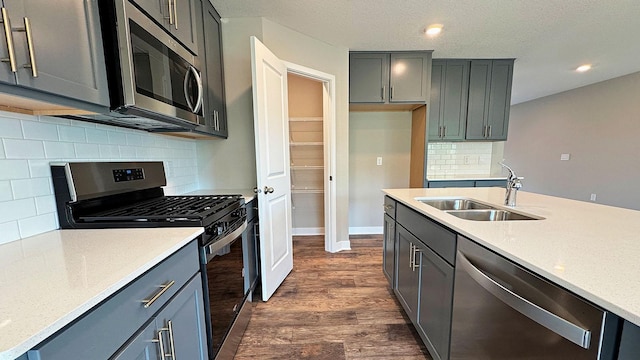 7856 Martin Ave NE, Otsego, MN 55330 - kitchen featuring appliances with stainless steel finishes, dark wood finished floors, decorative backsplash, recessed lighting, and a textured ceiling