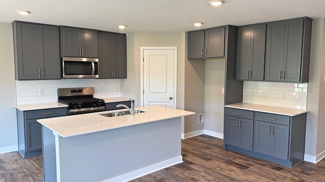 7856 Martin Ave NE, Otsego, MN 55330 - kitchen featuring appliances with stainless steel finishes, dark wood-style floors, tasteful backsplash, light countertops, and a textured ceiling
