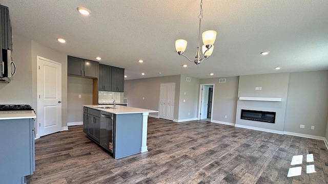 7856 Martin Ave NE, Otsego, MN 55330 - kitchen with stainless steel dishwasher, dark wood finished floors, open floor plan, a textured ceiling, and light countertops