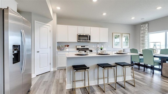 7856 Martin Ave NE, Otsego, MN 55330 - kitchen with appliances with stainless steel finishes, light wood-style floors, light countertops, white cabinetry, and recessed lighting