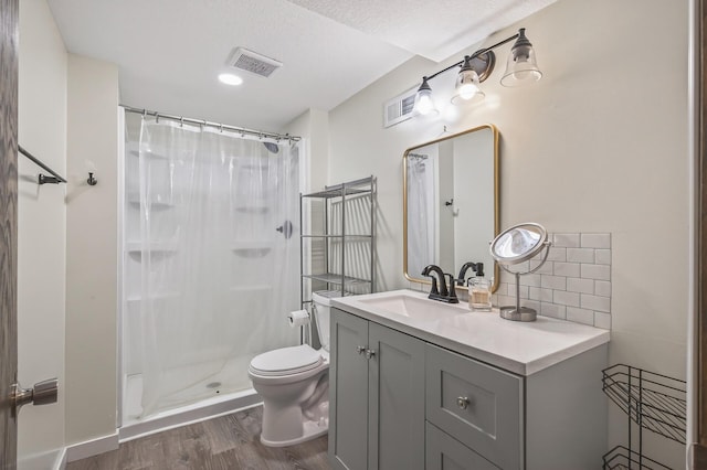 800-802 Parkview Ln, Champlin, MN 55316 - bathroom with wood finished floors, vanity, curtained shower, and tasteful backsplash