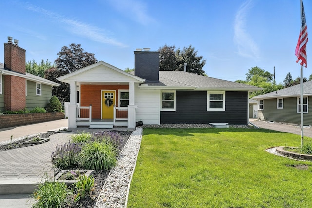 2638 Florida Ave S, Saint Louis Park, MN 55426 - view of front facade with covered porch, a front lawn, and a chimney