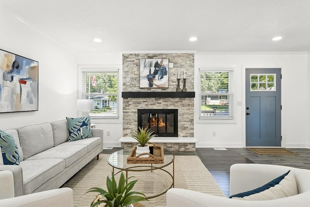 2638 Florida Ave S, Saint Louis Park, MN 55426 - living area with dark wood-style floors, plenty of natural light, crown molding, a stone fireplace, and recessed lighting
