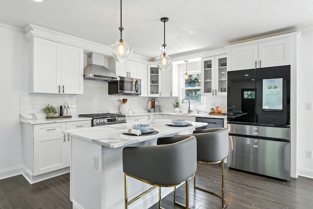 2638 Florida Ave S, Saint Louis Park, MN 55426 - kitchen with stainless steel appliances, wall chimney range hood, white cabinetry, dark wood-type flooring, and a textured ceiling
