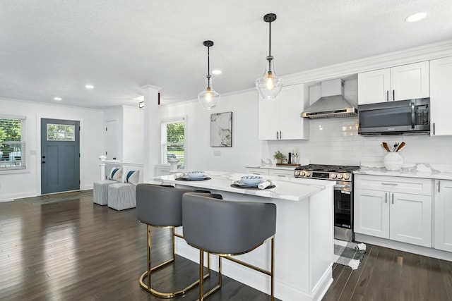2638 Florida Ave S, Saint Louis Park, MN 55426 - kitchen featuring wall chimney range hood, gas range, dark wood-style floors, white cabinets, and ornamental molding