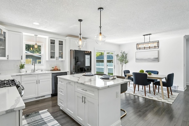 2638 Florida Ave S, Saint Louis Park, MN 55426 - kitchen with dishwasher, a textured ceiling, refrigerator, dark wood-style floors, and a center island