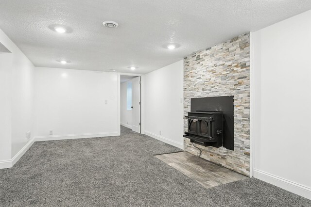2638 Florida Ave S, Saint Louis Park, MN 55426 - unfurnished living room with a textured ceiling, carpet flooring, and a wood stove