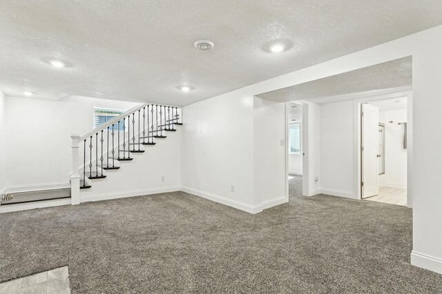 2638 Florida Ave S, Saint Louis Park, MN 55426 - below grade area featuring a textured ceiling, carpet, stairway, and healthy amount of natural light
