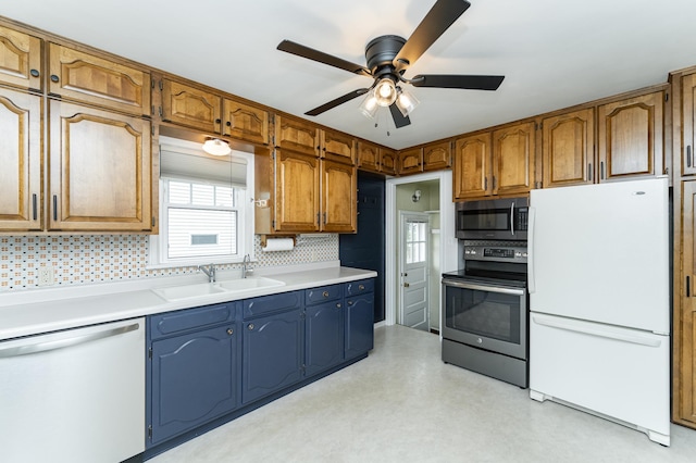 1007 12th Ave NE, Rochester, MN 55906 - kitchen with stainless steel appliances, ceiling fan, backsplash, light countertops, and brown cabinetry