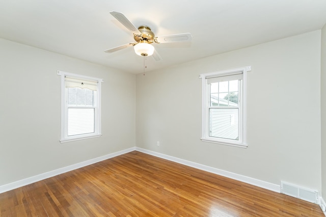 1007 12th Ave NE, Rochester, MN 55906 - unfurnished room with ceiling fan and wood finished floors