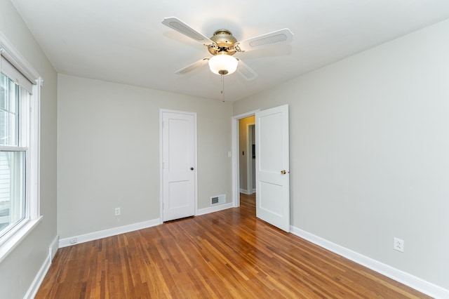 1007 12th Ave NE, Rochester, MN 55906 - empty room with wood finished floors and a ceiling fan