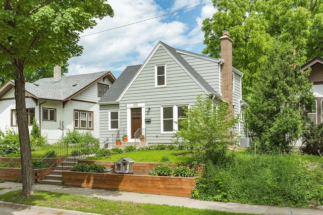 3615 33rd Ave S, Minneapolis, MN 55406 - view of front of property with a vegetable garden, a chimney, and a shingled roof