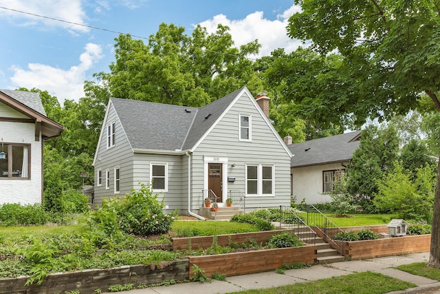 3615 33rd Ave S, Minneapolis, MN 55406 - bungalow featuring a garden, roof with shingles, and a chimney