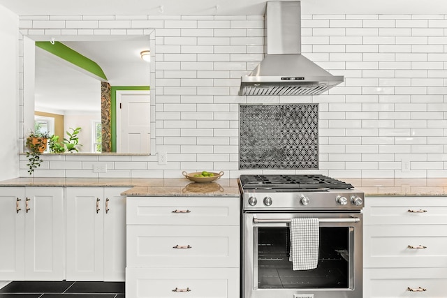 3615 33rd Ave S, Minneapolis, MN 55406 - kitchen with stainless steel gas stove, wall chimney range hood, tasteful backsplash, white cabinets, and light stone counters
