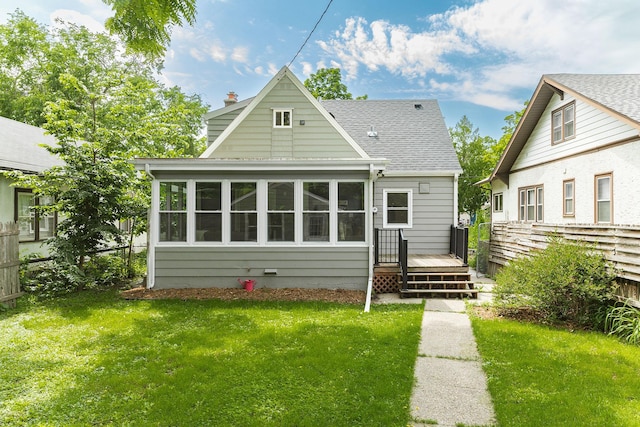 3615 33rd Ave S, Minneapolis, MN 55406 - rear view of house with a deck, a shingled roof, a sunroom, and a chimney