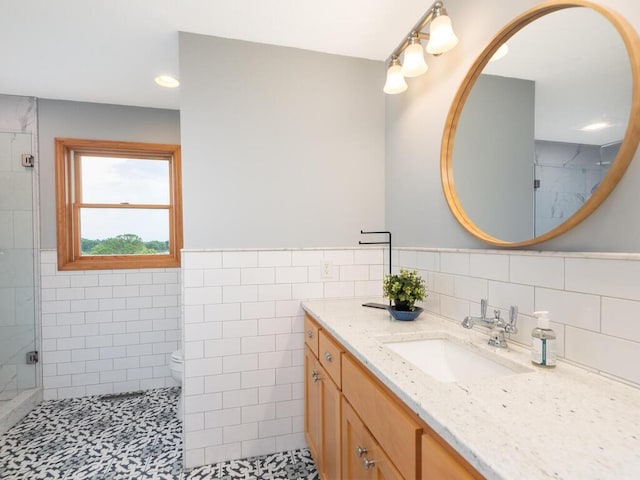68749 195th St, Darwin, MN 55324 - full bath featuring vanity, a stall shower, tile walls, a wainscoted wall, and recessed lighting