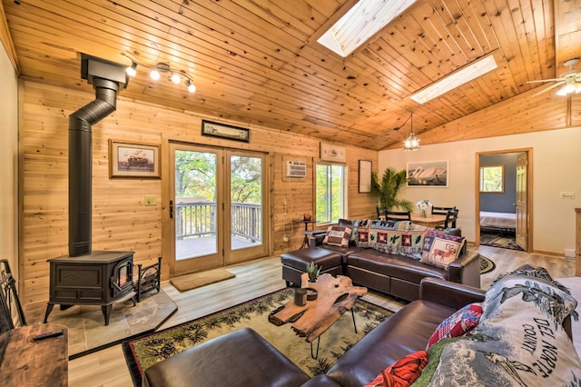 1952 75th Ave, Dresser, WI 54009 - living area with a wood stove, lofted ceiling, wood finished floors, a skylight, and wooden walls
