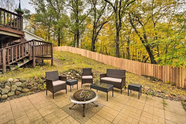 1952 75th Ave, Dresser, WI 54009 - fenced backyard featuring a patio area, a wooden deck, stairway, and an outdoor living space with a fire pit