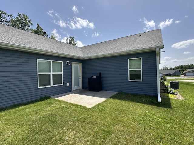 1817 Ridgewood Cir, Menomonie, WI 54751 - back of property with a yard, a patio area, and roof with shingles