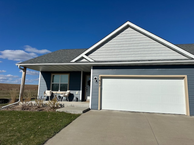1817 Ridgewood Cir, Menomonie, WI 54751 - view of front of property with covered porch, an attached garage, concrete driveway, and roof with shingles