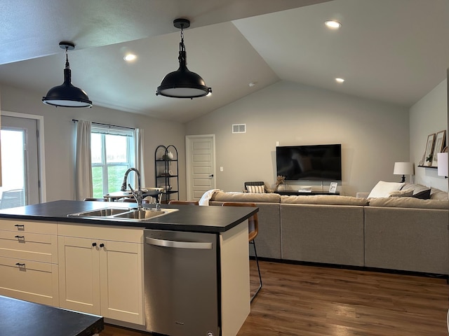 1817 Ridgewood Cir, Menomonie, WI 54751 - kitchen featuring dishwasher, dark countertops, open floor plan, lofted ceiling, and dark wood finished floors