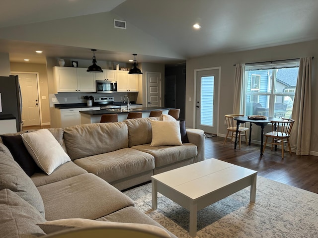 1817 Ridgewood Cir, Menomonie, WI 54751 - living area with vaulted ceiling, dark wood-type flooring, and recessed lighting