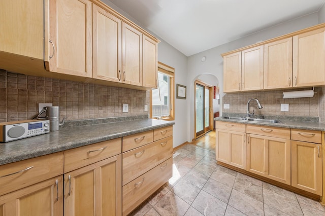 4105 31st Ave S, Minneapolis, MN 55406 - kitchen featuring light brown cabinets, arched walkways, decorative backsplash, and dark countertops