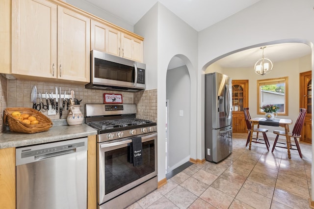 4105 31st Ave S, Minneapolis, MN 55406 - kitchen featuring stainless steel appliances, light brown cabinets, backsplash, light countertops, and a chandelier