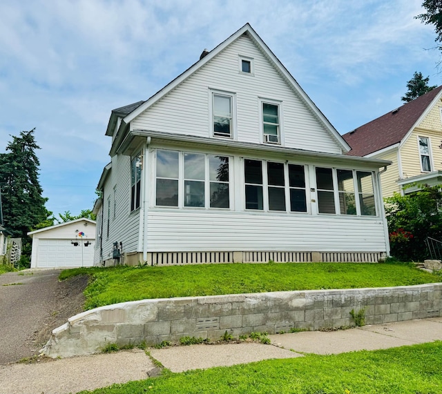 371 Sherburne Ave, Saint Paul, MN 55103 - view of front of house with an outbuilding, a garage, crawl space, a sunroom, and a front yard