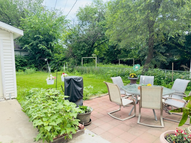 371 Sherburne Ave, Saint Paul, MN 55103 - view of patio with outdoor dining space, view of wooded area, and area for grilling