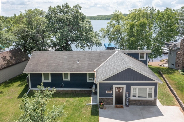 21865 512th Ln, Mcgregor, MN 55760 - view of front of property featuring a front lawn, a water view, roof with shingles, and stone siding