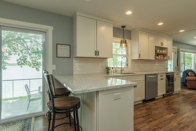 21865 512th Ln, Mcgregor, MN 55760 - kitchen with wine cooler, white cabinetry, a peninsula, decorative backsplash, and recessed lighting