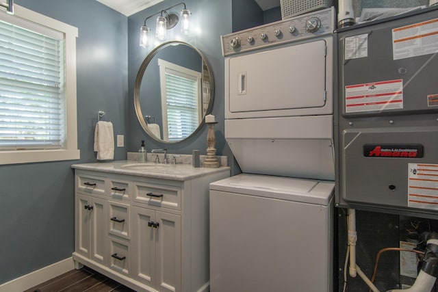21865 512th Ln, Mcgregor, MN 55760 - washroom with stacked washer and clothes dryer and dark wood-style flooring
