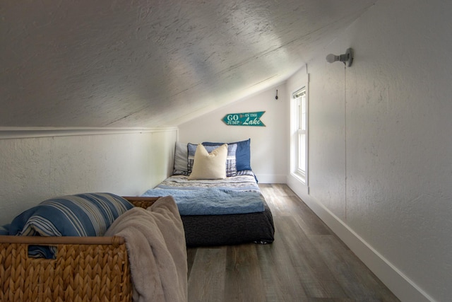 21865 512th Ln, Mcgregor, MN 55760 - bedroom with vaulted ceiling, wood finished floors, and a textured wall