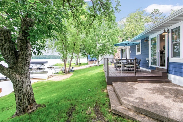 21865 512th Ln, Mcgregor, MN 55760 - view of green lawn featuring a deck with water view and outdoor dining space