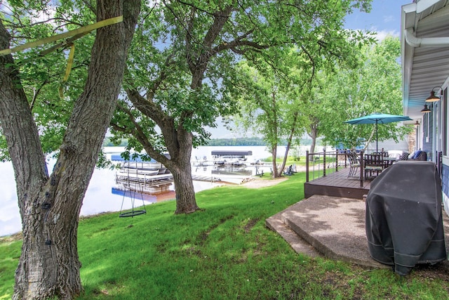 21865 512th Ln, Mcgregor, MN 55760 - view of grassy yard featuring a deck with water view and outdoor dining space