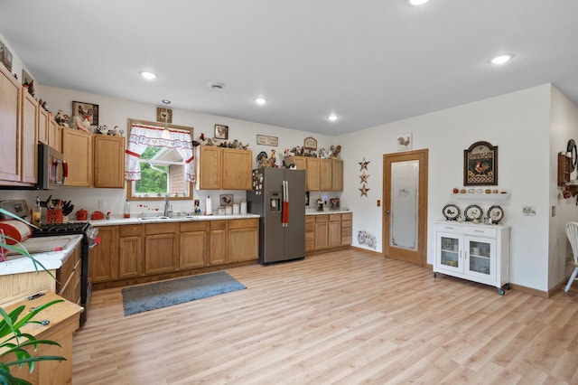 18981 247th Ave NW, Orrock Twp, MN 55309 - kitchen with stainless steel appliances, light countertops, light wood finished floors, recessed lighting, and brown cabinets