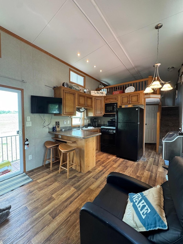 40716 Placid Dr, Dent, MN 56528 - kitchen with black appliances, a peninsula, vaulted ceiling, brown cabinets, and healthy amount of natural light