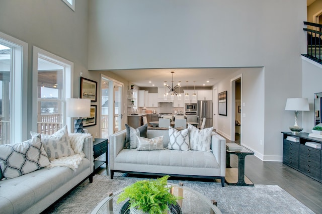 18210 102nd Pl N, Maple Grove, MN 55311 - living room with a high ceiling, dark wood-style floors, a chandelier, and healthy amount of natural light