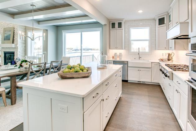 18210 102nd Pl N, Maple Grove, MN 55311 - kitchen featuring stainless steel appliances, beam ceiling, plenty of natural light, a center island, and under cabinet range hood