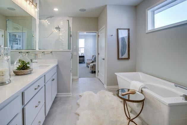 18210 102nd Pl N, Maple Grove, MN 55311 - ensuite bathroom featuring a freestanding bath, vanity, a shower with shower door, and recessed lighting