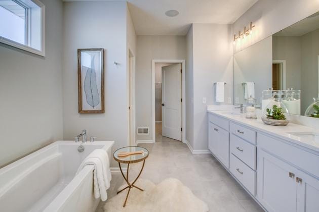 18210 102nd Pl N, Maple Grove, MN 55311 - bathroom featuring a bathtub and double vanity