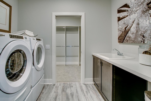 18210 102nd Pl N, Maple Grove, MN 55311 - washroom with independent washer and dryer, cabinet space, and light wood-type flooring