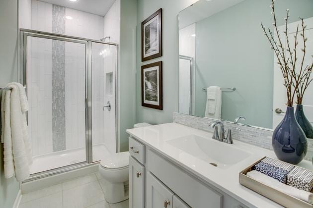18210 102nd Pl N, Maple Grove, MN 55311 - bathroom with vanity, a shower stall, and tile patterned flooring