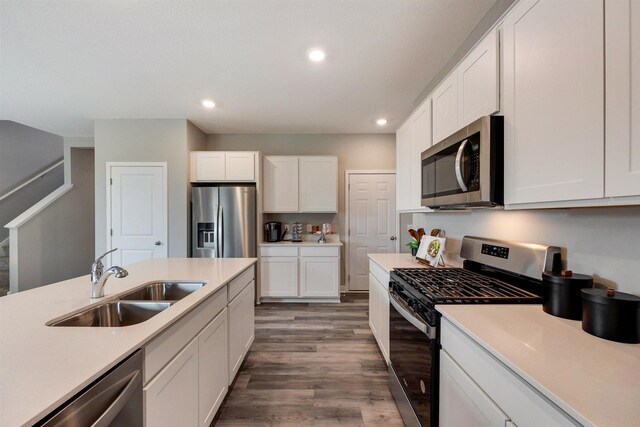 17021 Draper Way, Lakeville, MN 55044 - kitchen featuring appliances with stainless steel finishes, light countertops, recessed lighting, wood finished floors, and white cabinetry